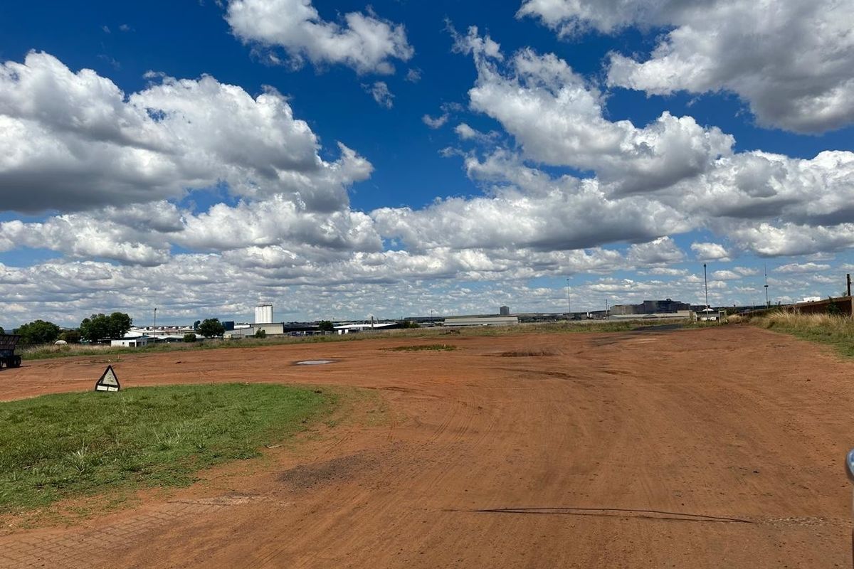 Expansive industrial land plot featuring unpaved ground and open space, suitable for development or storage purposes.