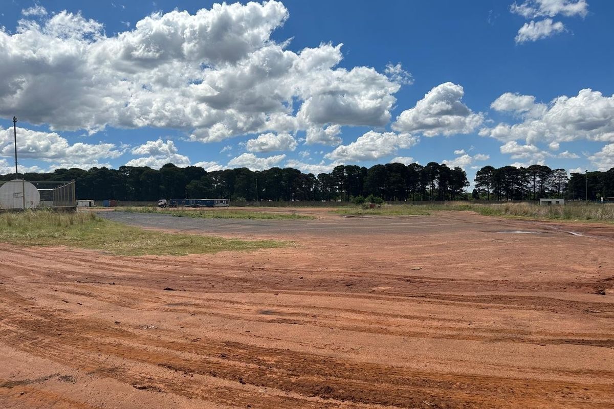 Expansive industrial land plot featuring unpaved ground and open space, suitable for development or heavy vehicle storage.