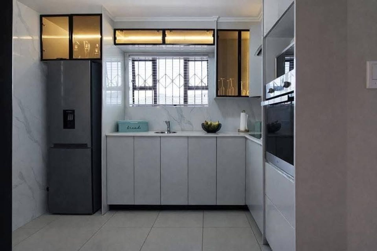 A modern, well-maintained kitchen featuring sleek cabinetry, integrated oven, stone countertops, and stylish glass-fronted overhead storage with ambient lighting.