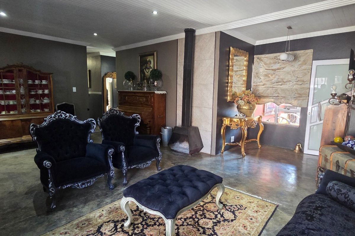 Spacious living room featuring a central freestanding fireplace, polished concrete flooring, and recessed ceiling lighting.