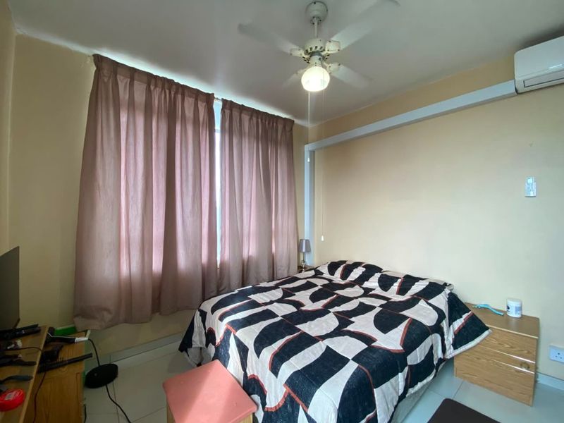 A functional bedroom featuring a ceiling fan, wall-mounted air conditioning unit, and large window with curtains.