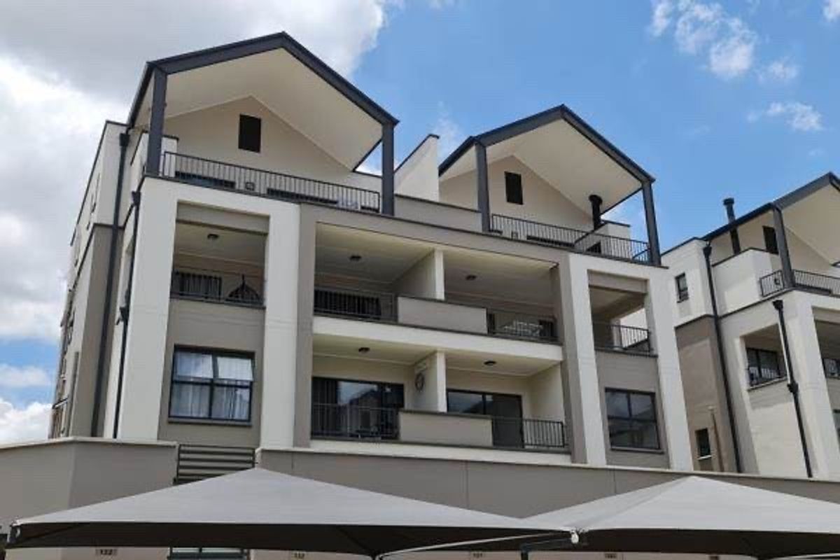 A modern multi-story apartment complex featuring contemporary architectural design, private balconies, and clean exterior finishes.