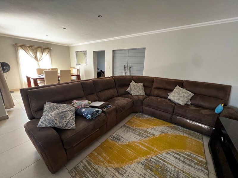 Open plan living and dining area featuring tiled flooring, recessed ceiling lighting, and neutral wall finishes.