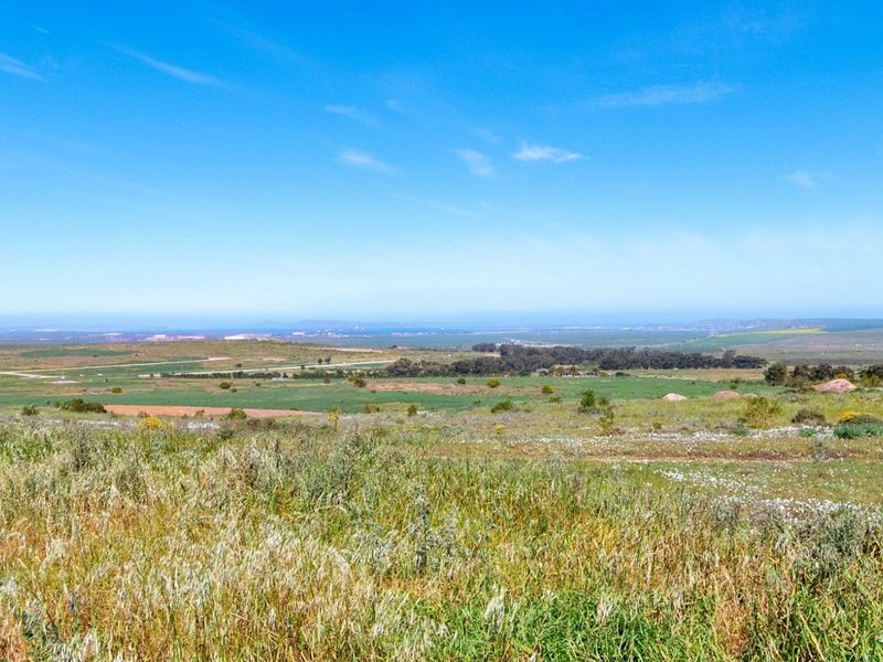 Expansive view of the surrounding natural landscape and open fields, showcasing the scenic potential of this vacant residential land.