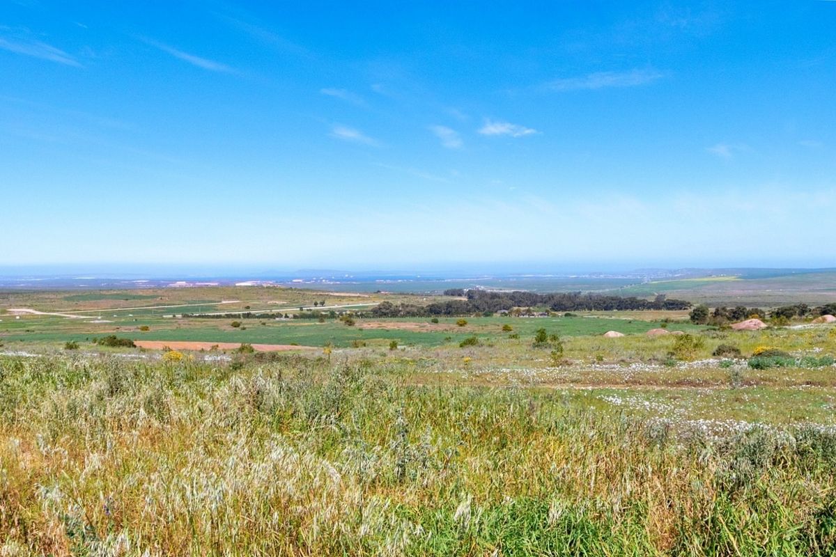 Expansive view of the surrounding natural landscape and open fields, showcasing the scenic potential of this vacant residential land.