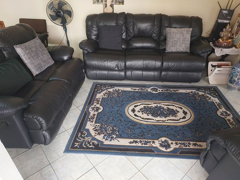 A living room area featuring light-colored ceramic floor tiles.