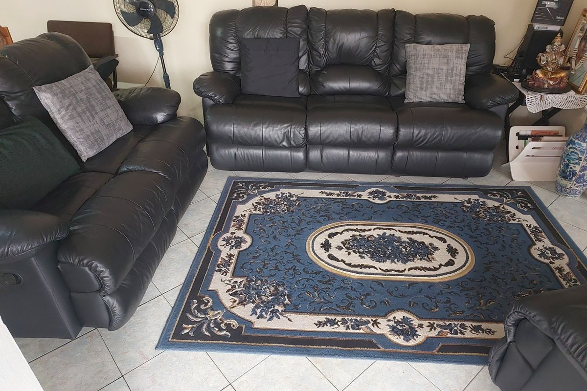 A living room area featuring light-colored ceramic floor tiles.