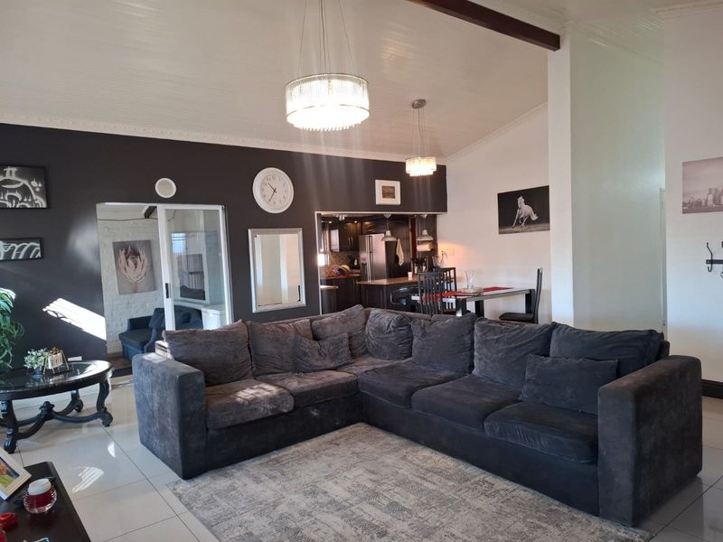 Open plan living and dining area featuring tiled flooring, recessed lighting, and a seamless flow into the adjacent kitchen space.