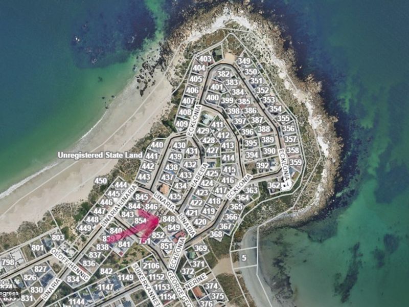 An aerial view of a coastal residential estate showing the layout of land parcels and street infrastructure.