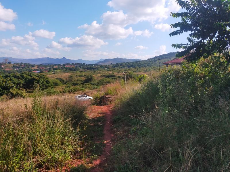 A scenic view overlooking a natural landscape with rolling hills and distant mountains, showcasing the property's surrounding environment.