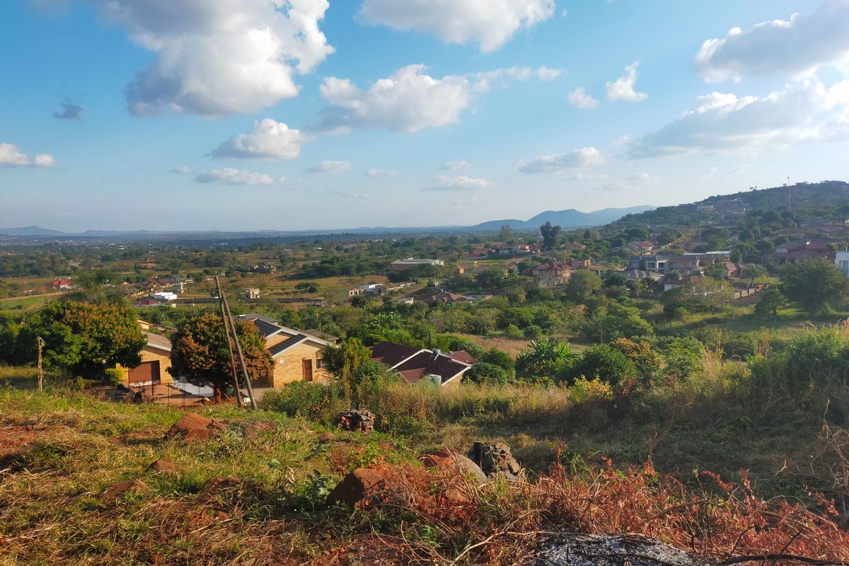 A scenic elevated view overlooking a residential neighborhood and surrounding landscape, showcasing the natural terrain and local area.