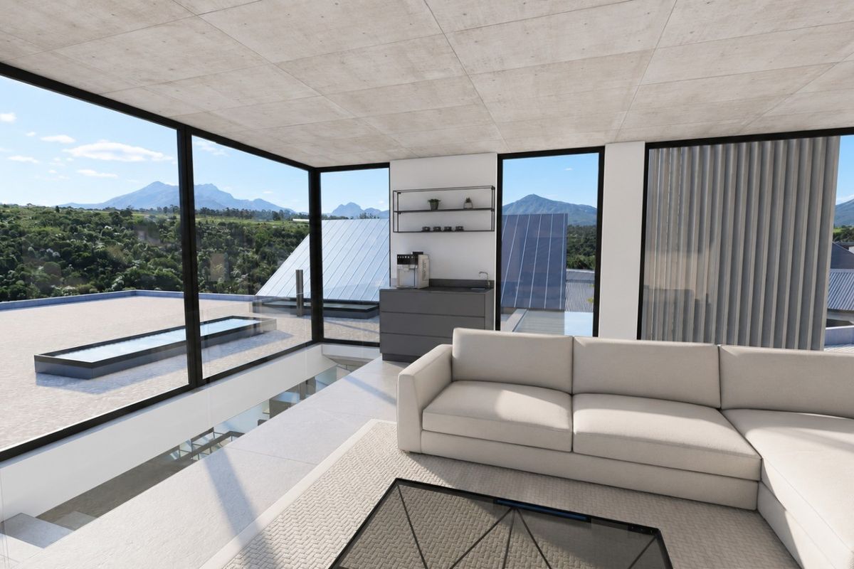 Modern living area featuring floor-to-ceiling windows with expansive mountain views, exposed concrete ceilings, and sleek tiled flooring.