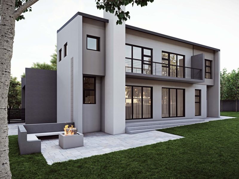 Modern two-story residential exterior featuring a paved patio area with a built-in fire pit, balcony, and landscaped garden.
