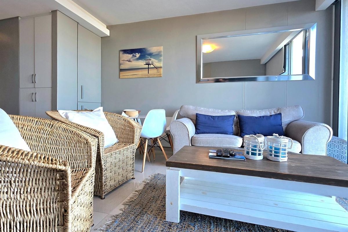 A bright living area featuring neutral wall tones, tiled flooring, and built-in cabinetry, creating a comfortable and functional space.