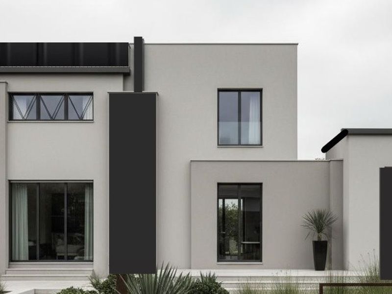 A modern, minimalist two-story house featuring clean lines, neutral grey render, and large dark-framed windows, set within a landscaped garden.