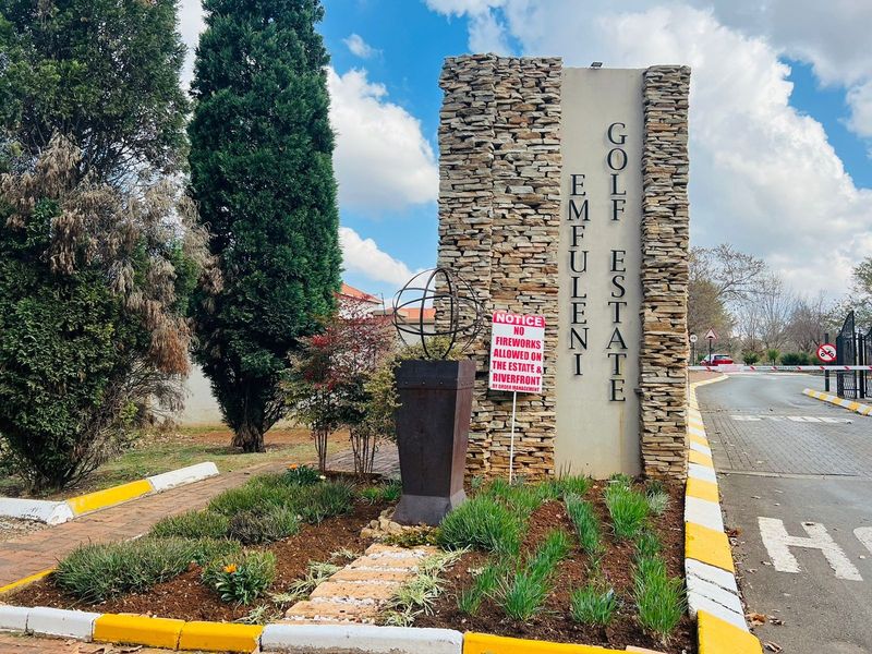 Entrance signage for Emfuleni Golf Estate, featuring stone cladding and landscaped garden beds at the secure access point.