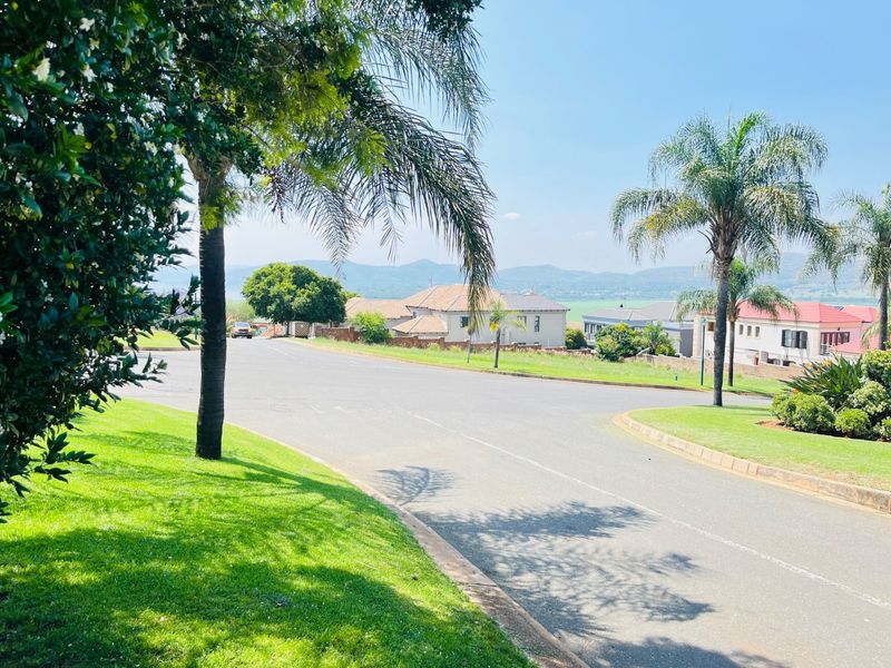 A view of the residential street and surrounding neighbourhood landscape, showcasing the established greenery and local road infrastructure.
