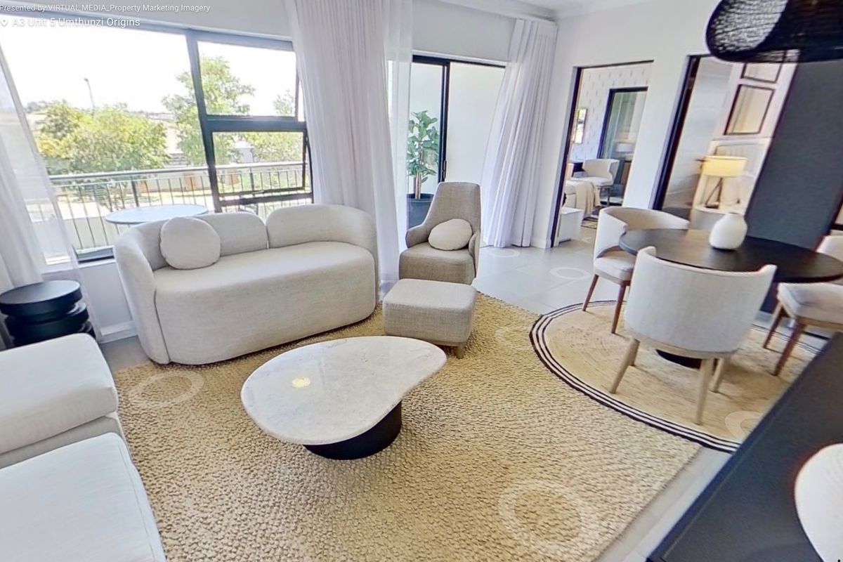 Bright open-plan living and dining area featuring large sliding glass doors that provide ample natural light and seamless access to the balcony.