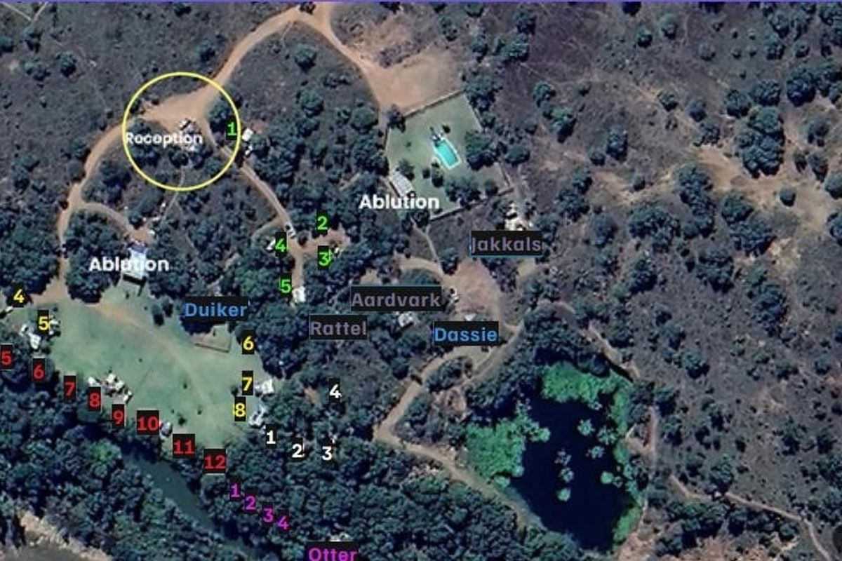 Aerial view of the farm property layout, showing the distribution of various accommodation units, reception area, ablution facilities, and natural landscape features.