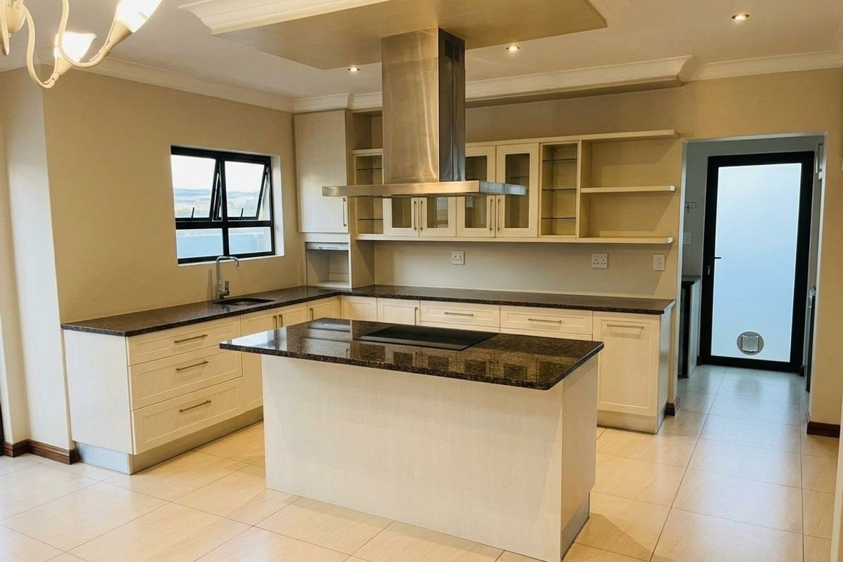 Modern kitchen featuring a central island with integrated cooktop, stainless steel extractor fan, granite countertops, and ample cabinetry.
