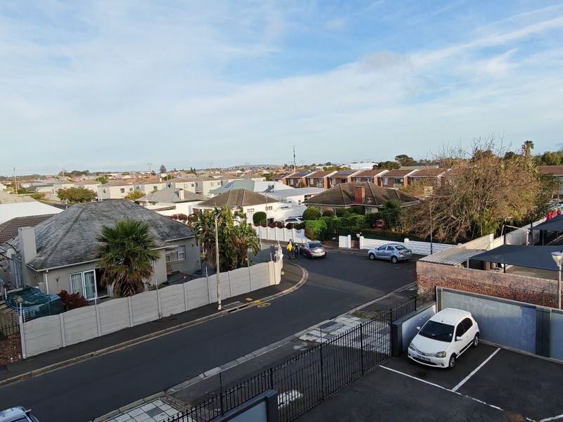Elevated view overlooking the surrounding residential neighbourhood, street infrastructure, and parking area.