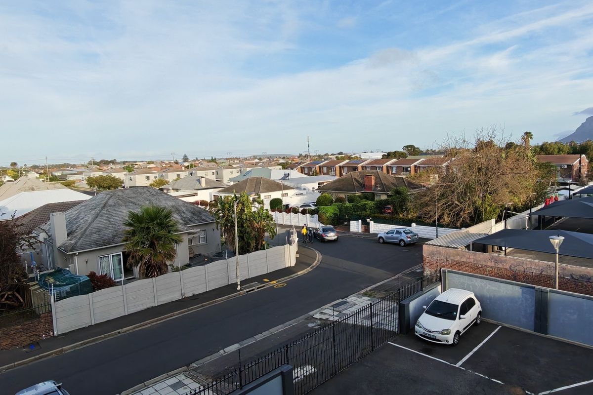 Elevated view overlooking the surrounding residential neighbourhood, street infrastructure, and parking area.