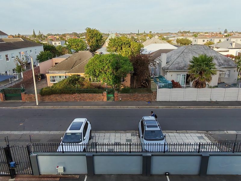 An elevated street-facing view overlooking the surrounding residential neighbourhood, featuring paved parking areas and secure perimeter fencing.