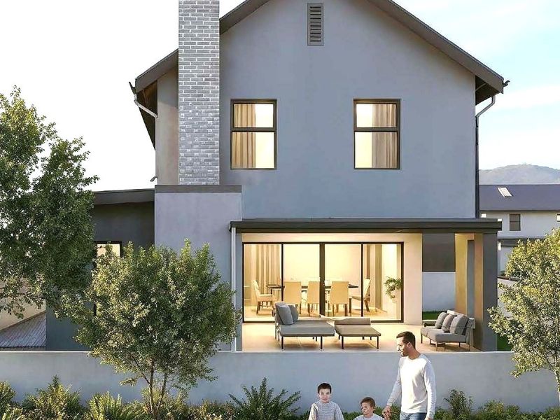 A modern two-story residential home featuring a brick chimney, covered patio with sliding glass doors, and a landscaped garden area.