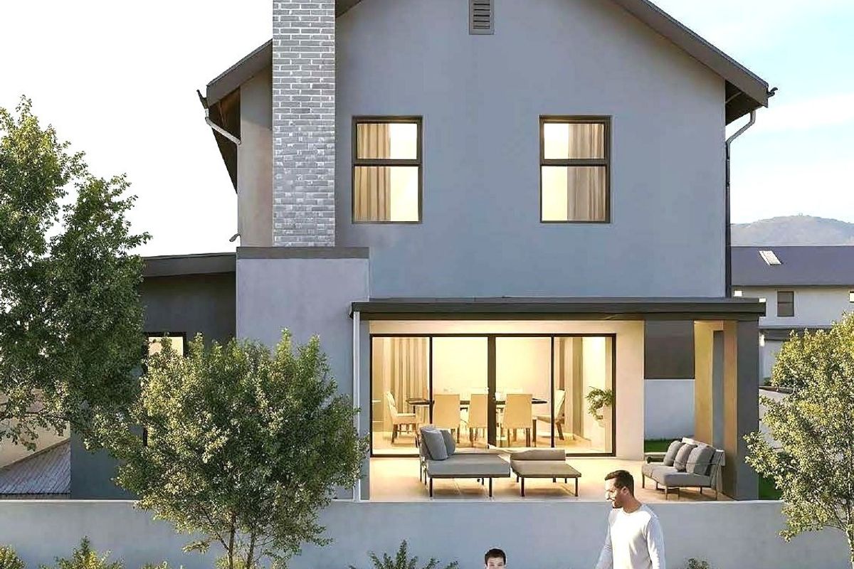 A modern two-story residential home featuring a brick chimney, covered patio with sliding glass doors, and a landscaped garden area.