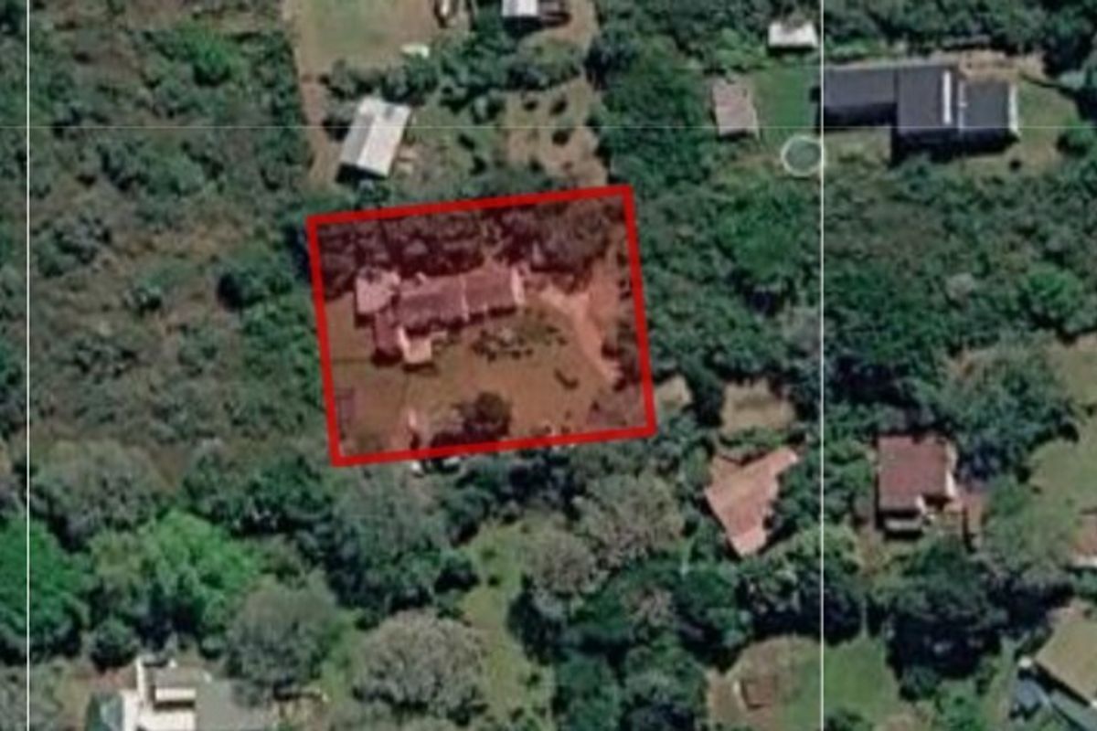 An aerial view of the property showing the house footprint and surrounding garden area within the highlighted boundary.