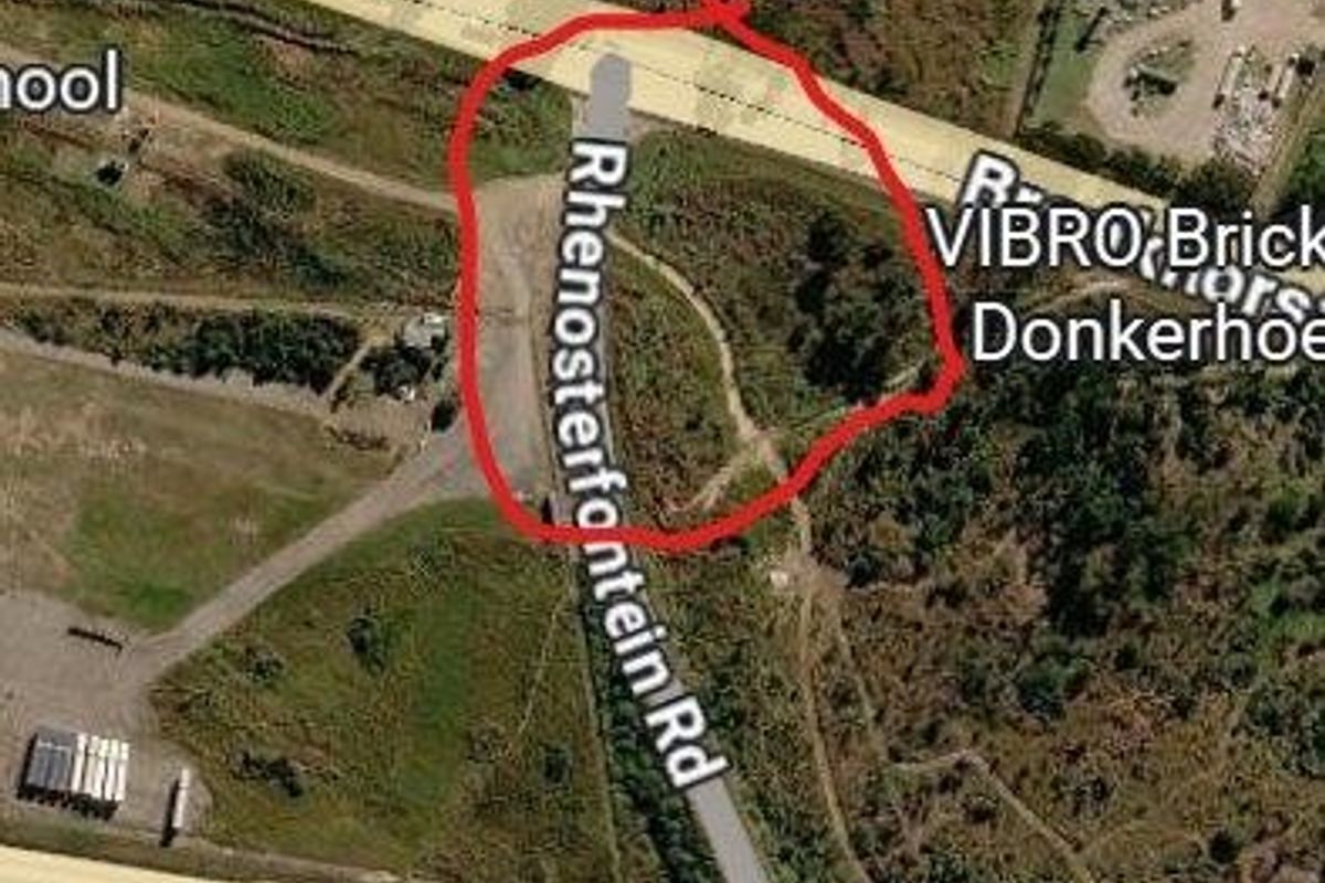 Aerial view of a vacant residential land parcel located near Rhenosterfontein Road and the R104 highway intersection.