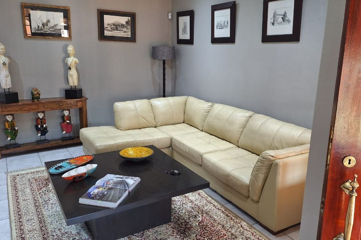 A comfortable living room featuring tiled flooring and neutral wall finishes, providing a functional and inviting space for relaxation.