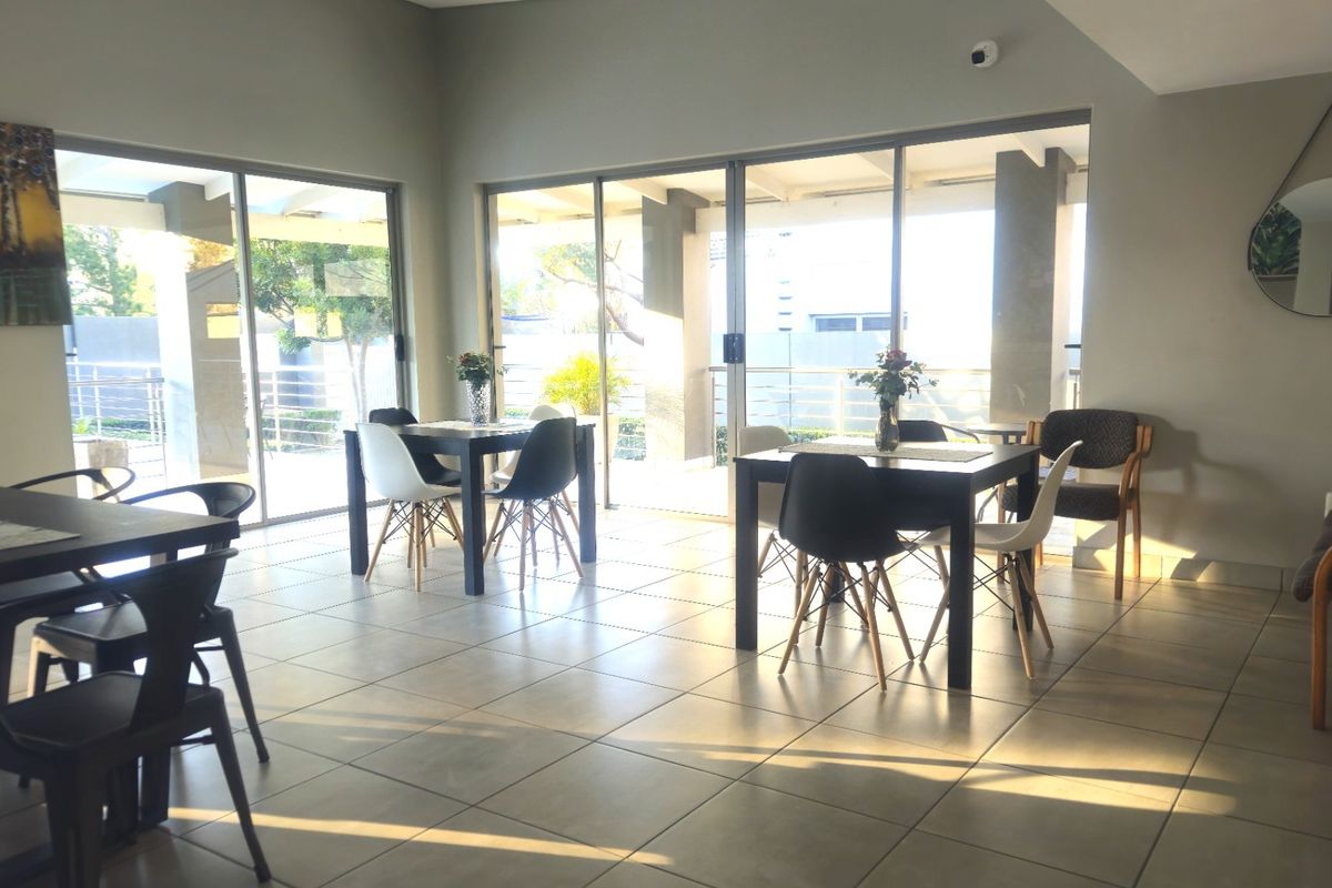 Spacious living area featuring large sliding glass doors that provide ample natural light and access to an outdoor patio space.