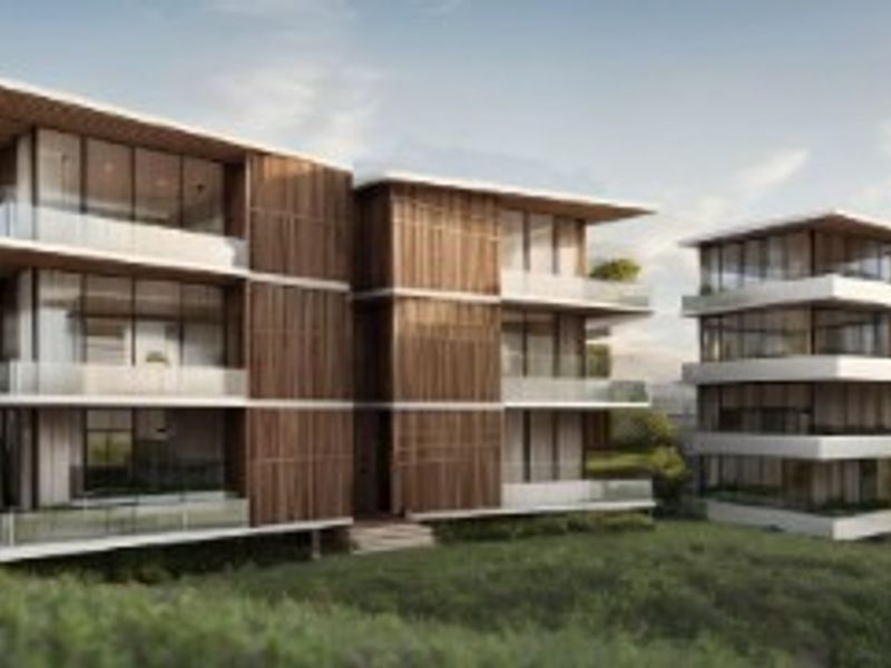 Architectural rendering of a modern multi-story residential development featuring timber cladding, expansive glass facades, and private balconies set within a landscaped environment.