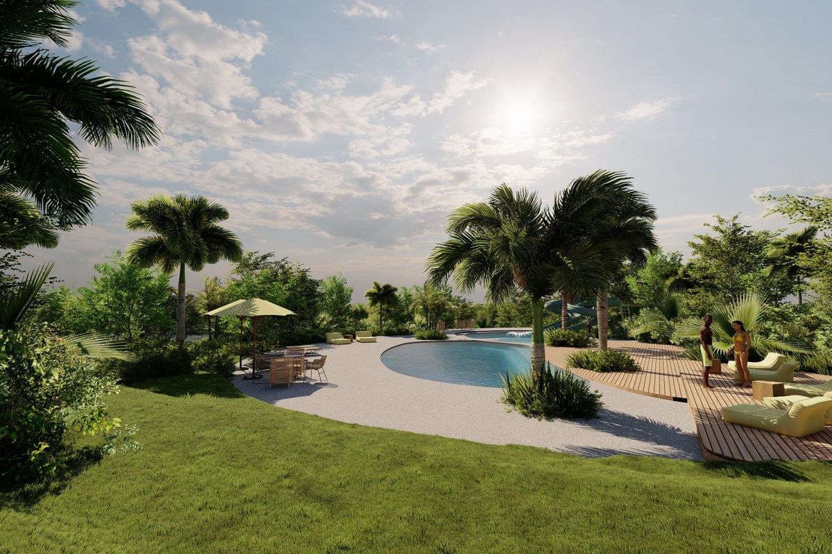 A beautifully landscaped outdoor pool area featuring a swimming pool, timber decking, and lush tropical garden surroundings.