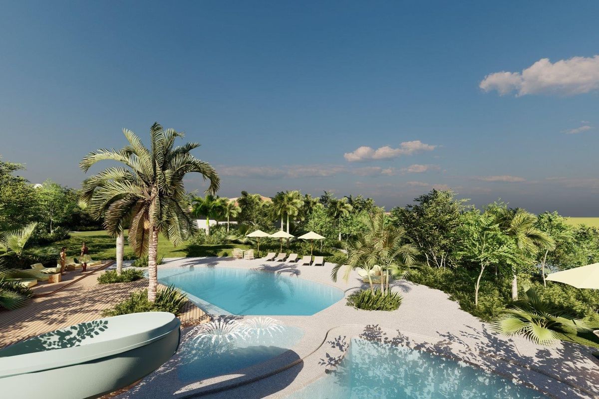 A beautifully landscaped outdoor pool area featuring a swimming pool, wooden decking, and lush tropical garden surroundings.
