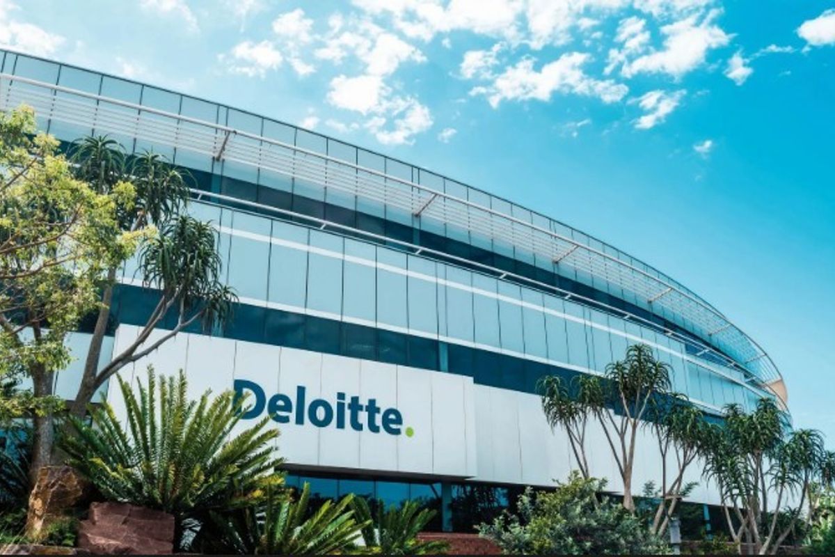 Modern commercial office building featuring a sleek glass facade, metal paneling, and integrated sun shading systems in a professional landscaped setting.