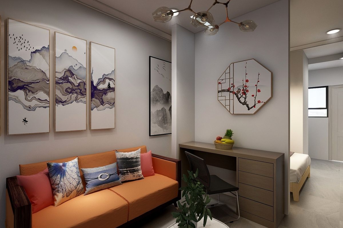 A modern living area featuring a built-in desk, contemporary lighting, and a clean, minimalist aesthetic with a view into the adjacent bedroom.