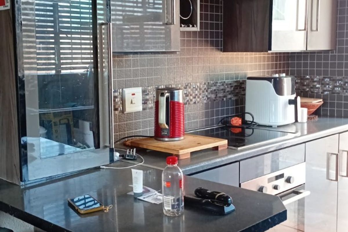 Modern kitchen featuring sleek cabinetry, granite countertops, integrated appliances, and a convenient breakfast bar for casual dining.