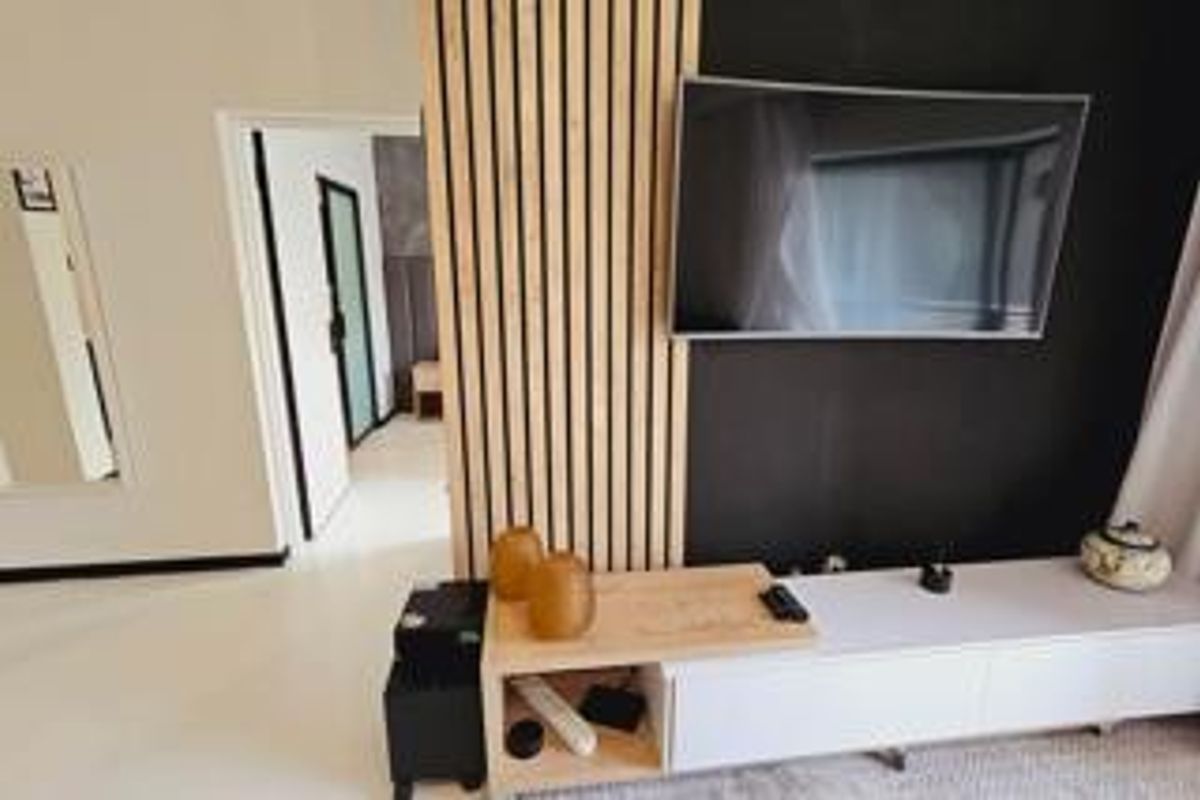 A modern living room featuring a stylish timber slat feature wall and a sleek built-in media console.
