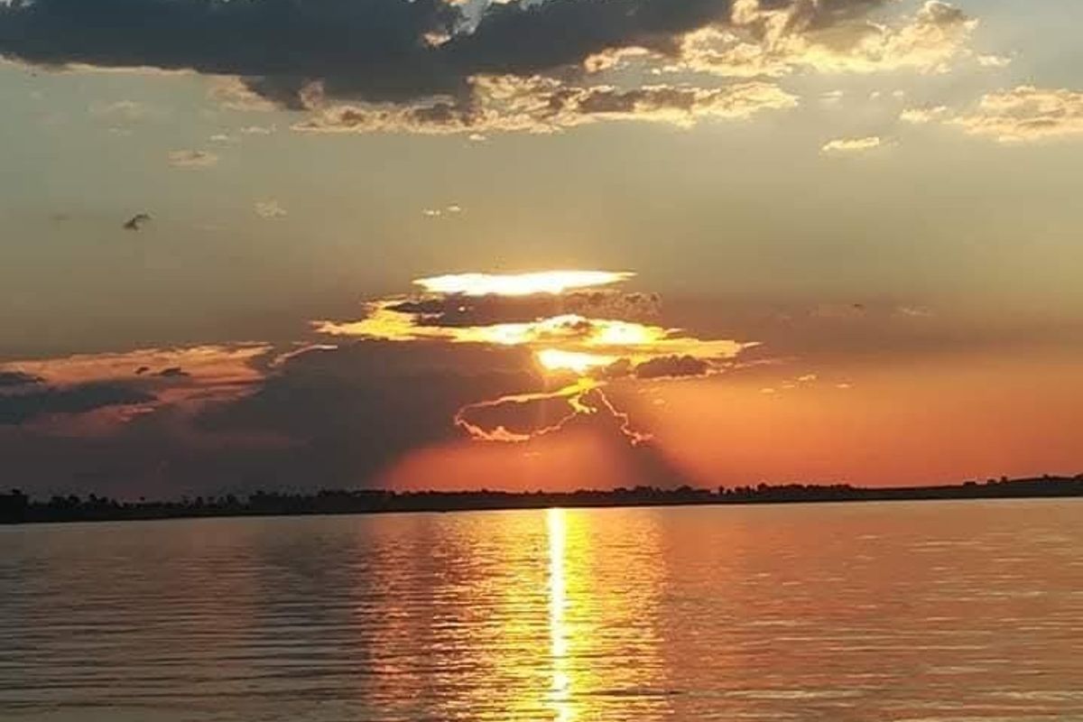 A scenic sunset view over a body of water, highlighting the natural landscape surrounding the property.