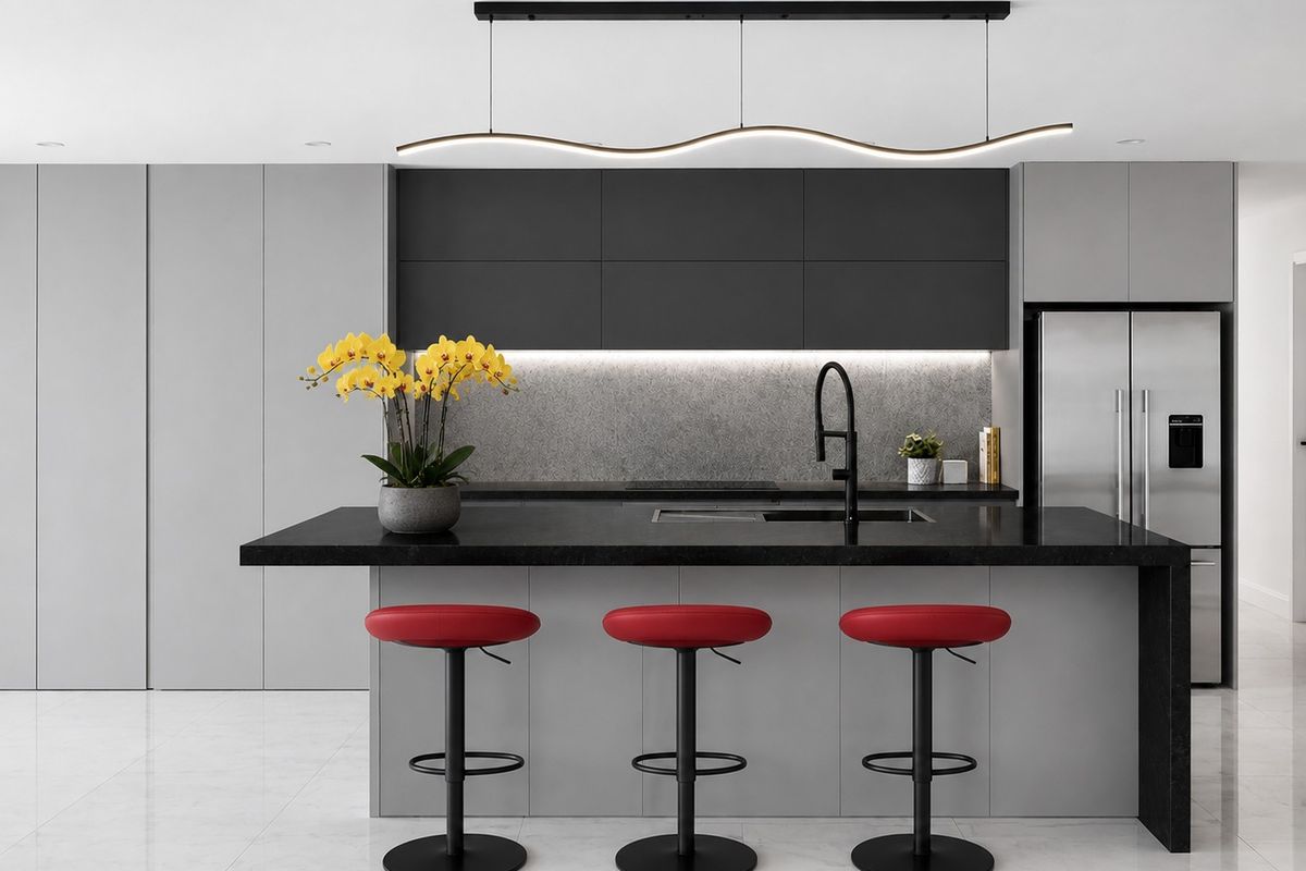 Modern kitchen featuring a sleek island with stone countertop, matte black fixtures, integrated appliances, and minimalist grey cabinetry with ambient under-cabinet lighting.