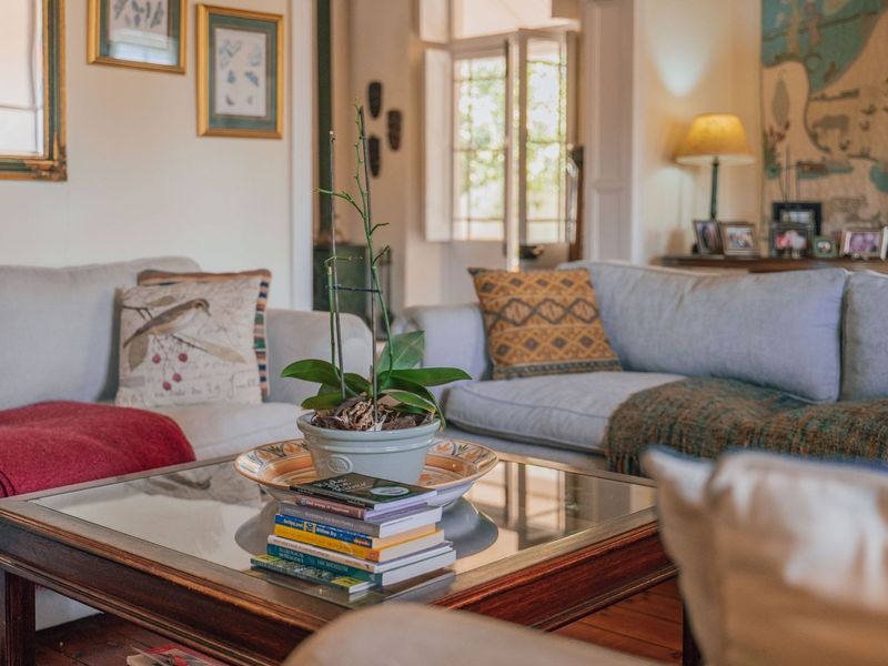 A cozy living room featuring warm timber flooring and classic french doors leading to an outdoor area, creating a bright and inviting atmosphere.