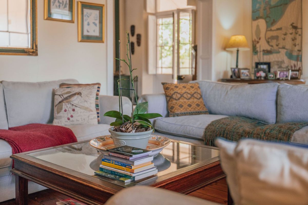 A cozy living room featuring warm timber flooring and classic french doors leading to an outdoor area, creating a bright and inviting atmosphere.