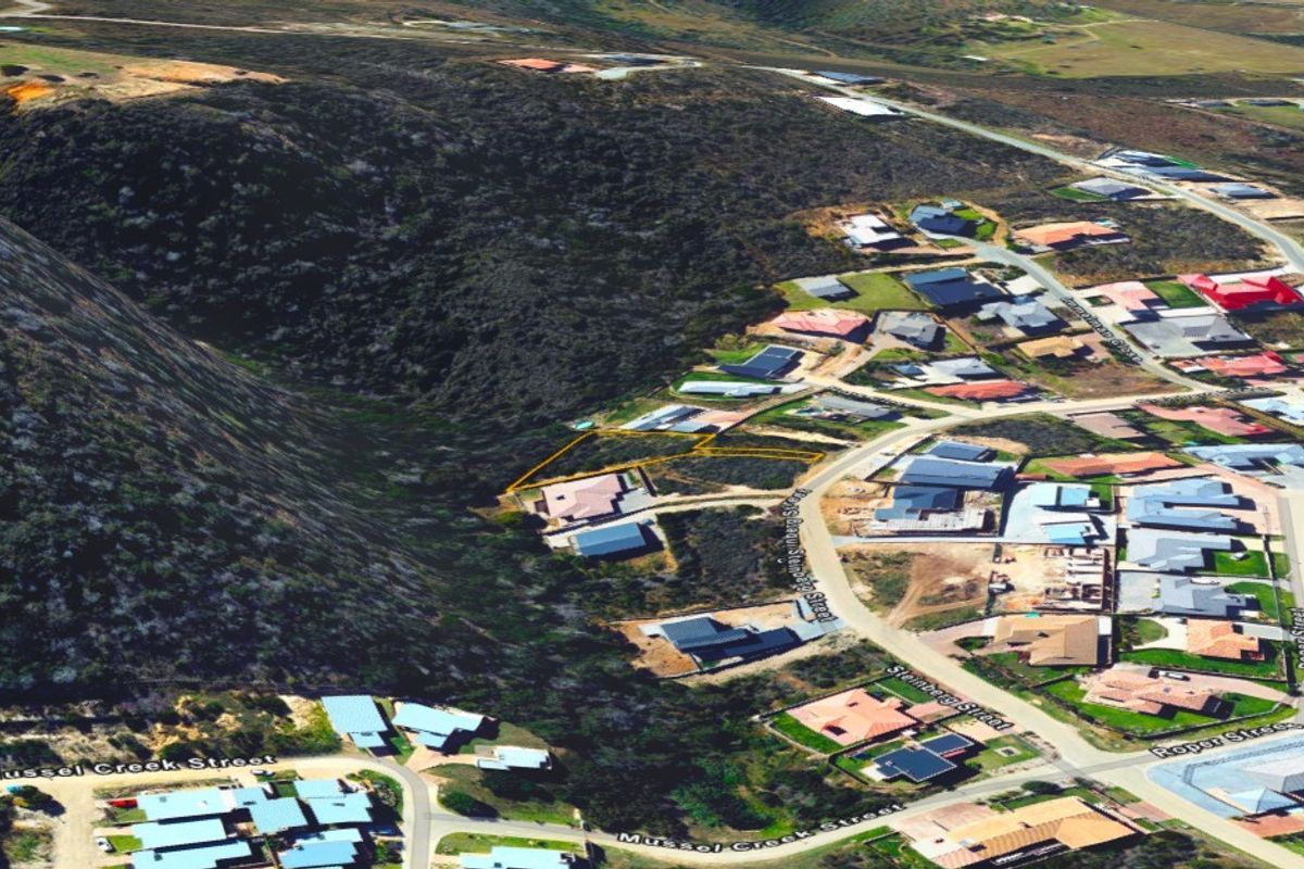 An aerial view showing the residential vacant land plot with surrounding neighborhood infrastructure and street access.