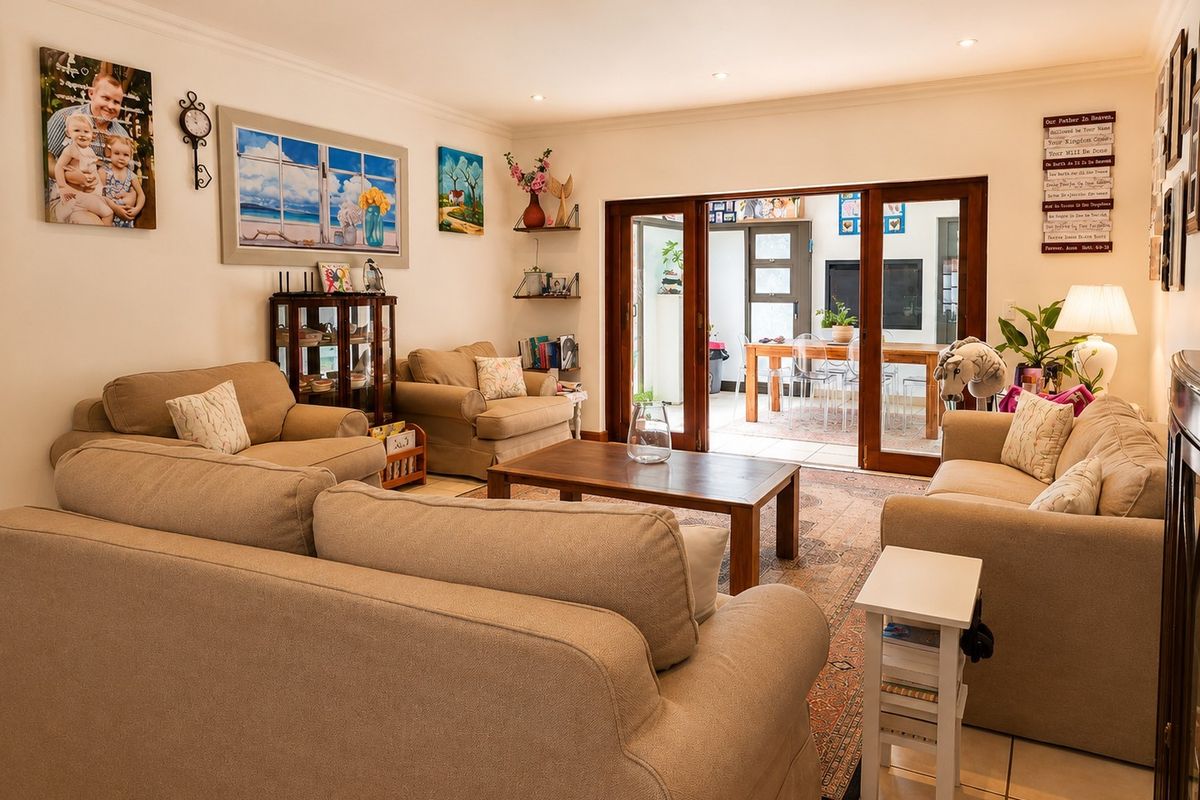 A well-maintained living room featuring tiled flooring, recessed downlighting, and large sliding glass doors that provide seamless access to an outdoor patio area.