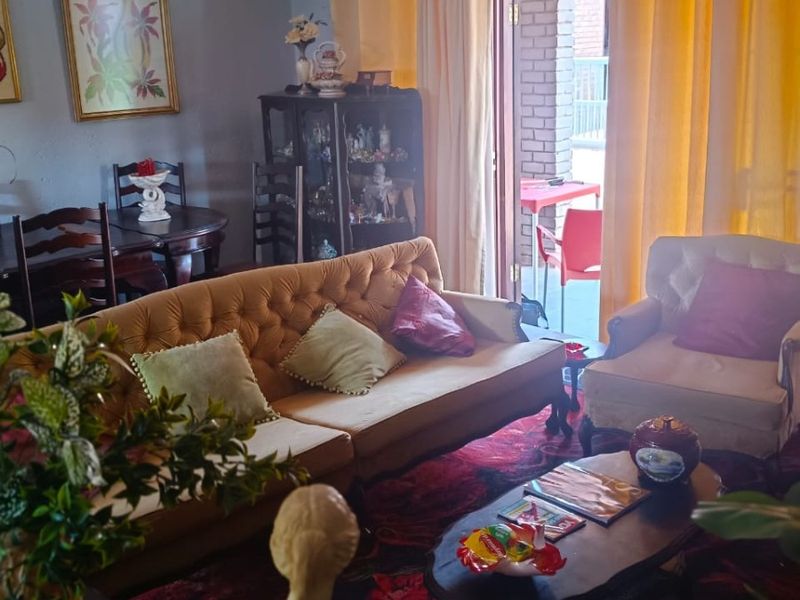 A living room area featuring a sliding glass door providing access to an outdoor patio space.