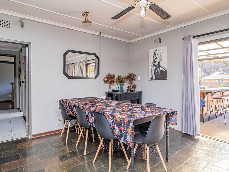 Dining room featuring slate tile flooring, a ceiling fan, and direct access to the outdoor patio area through a sliding glass door.