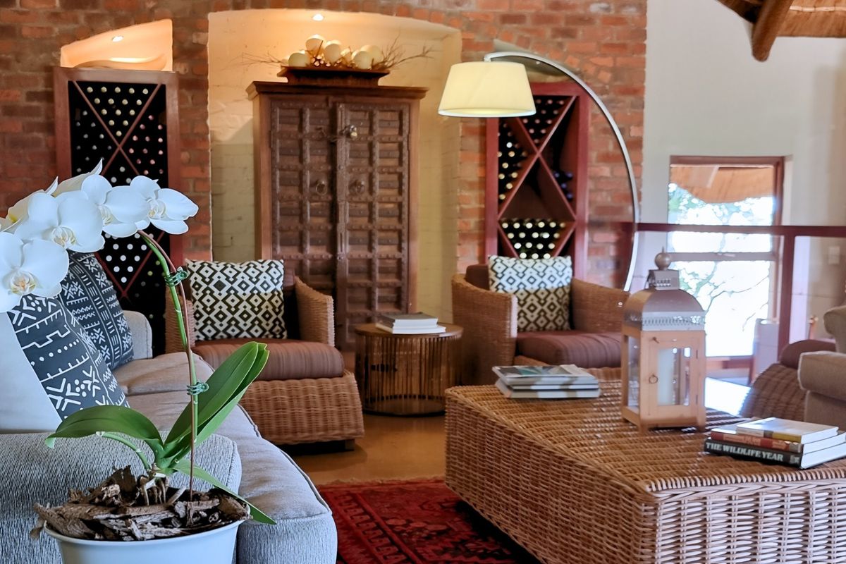 A cozy living area featuring exposed brick walls, built-in wine storage racks, and arched architectural alcoves, creating a warm and rustic atmosphere.