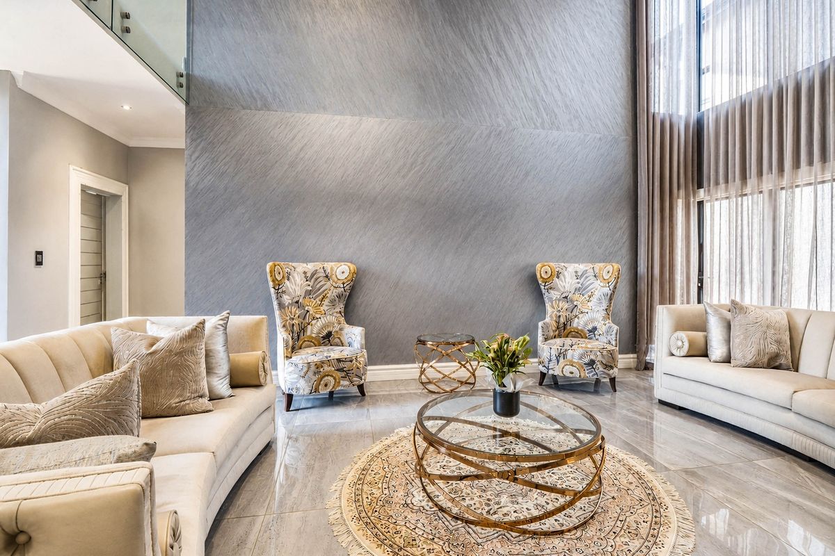 Spacious double-volume living room featuring a striking textured feature wall, polished porcelain flooring, and expansive full-height windows with elegant drapery.
